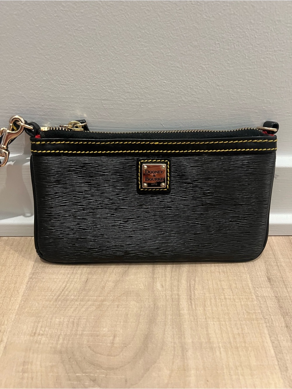 Dooney & Bourke Black Leather Wristlet with Yellow Stitching and Gold Hardware